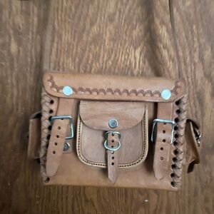 Raw leather tooled purse